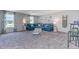 Bright living room with large blue sofa, white accents, and natural light from two large windows at 1429 Nokota Dr., Conway, SC 29526