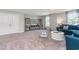 Spacious living room featuring comfortable blue sofa, white coffee table, and modern entertainment center at 1429 Nokota Dr., Conway, SC 29526