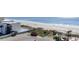 Elevated view of a condo resort, beach, and ocean; shows parking area, vegetation, and walkways at 1501 S Ocean Blvd. # 805, Myrtle Beach, SC 29577
