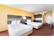 Comfortable bedroom featuring two beds, a kitchenette, and a cozy ambiance for relaxation at 1501 S Ocean Blvd. # 805, Myrtle Beach, SC 29577