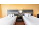 Cozy bedroom featuring two beds and a stylish headboard with a bedside table and lamp at 1501 S Ocean Blvd. # 805, Myrtle Beach, SC 29577