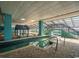An indoor pool area with turquoise decor, a fountain, and lounge seating under a glass ceiling at 1501 S Ocean Blvd. # 805, Myrtle Beach, SC 29577