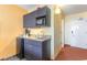 A compact kitchenette area features granite counters and gray cabinets at 1501 S Ocean Blvd. # 805, Myrtle Beach, SC 29577