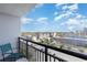 Balcony with a teal chair overlooking a city view and cloudy sky at 1501 S Ocean Blvd. # 915, Myrtle Beach, SC 29577
