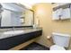Neat bathroom with vanity, granite countertop, sink, toilet, and a shower at 1501 S Ocean Blvd. # 915, Myrtle Beach, SC 29577