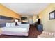Cozy bedroom with two beds, kitchenette, television, desk, and comfortable furnishings at 1501 S Ocean Blvd. # 915, Myrtle Beach, SC 29577