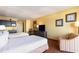 Comfortable bedroom featuring two beds, TV, lounge chair, and kitchenette area at 1501 S Ocean Blvd. # 915, Myrtle Beach, SC 29577