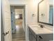 Bathroom vanity featuring a gray cabinet, white countertop, and views into the kitchen at 1514 Saw Palmetto St., North Myrtle Beach, SC 29582