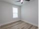 Bright bedroom featuring hardwood flooring, a window with blinds, and white trim at 1514 Saw Palmetto St., North Myrtle Beach, SC 29582