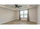 Bedroom with tray ceiling, ceiling fan, and a large window with curtains for ample natural light at 1514 Saw Palmetto St., North Myrtle Beach, SC 29582