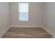 Neutral bedroom features ceiling fan, hardwood flooring, and a window at 1514 Saw Palmetto St., North Myrtle Beach, SC 29582