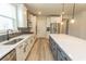 Bright kitchen features white cabinets, a large island, stainless steel appliances and modern finishes at 1514 Saw Palmetto St., North Myrtle Beach, SC 29582