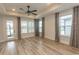 Living room features hardwood flooring, ceiling fan, natural light and neutral paint palette at 1514 Saw Palmetto St., North Myrtle Beach, SC 29582