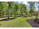 Lush backyard featuring a manicured lawn and outdoor bar at 155 Preservation Circle, Pawleys Island, SC 29585