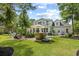 Expansive backyard featuring manicured lawn, patio, bar, and lush greenery at 155 Preservation Circle, Pawleys Island, SC 29585