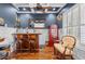 Basement bar featuring dark blue walls, custom bar, two barstools, and unique decor at 155 Preservation Circle, Pawleys Island, SC 29585