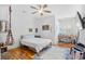 Comfortable bedroom with a full-sized bed, hardwood floors, and lots of natural light at 155 Preservation Circle, Pawleys Island, SC 29585