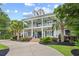 Beautiful two-story home with a charming double porch and well-manicured landscaping at 155 Preservation Circle, Pawleys Island, SC 29585