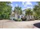 Charming two-story house featuring an attached garage and well-maintained landscaping at 155 Preservation Circle, Pawleys Island, SC 29585
