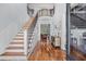 Grand foyer featuring hardwood floors, a staircase with iron railings, and elegant wainscoting at 155 Preservation Circle, Pawleys Island, SC 29585