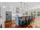 Bright, open kitchen featuring a center island, stainless steel appliances, and a dining area with ample natural light at 155 Preservation Circle, Pawleys Island, SC 29585