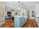Stylish kitchen island with a white countertop and blue cabinets, overlooking the living room at 155 Preservation Circle, Pawleys Island, SC 29585