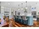 Elegant kitchen with a blue island, pendant lighting, and hardwood floors at 155 Preservation Circle, Pawleys Island, SC 29585