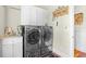 Laundry room with modern appliances, marble countertops, custom cabinets, and decor at 155 Preservation Circle, Pawleys Island, SC 29585