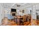 Cozy living room featuring a brick fireplace, hardwood floors, and built-in shelving at 155 Preservation Circle, Pawleys Island, SC 29585