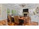 Spacious living room with hardwood floors, a coffered ceiling, and a brick fireplace at 155 Preservation Circle, Pawleys Island, SC 29585