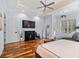 Bright main bedroom featuring dark furniture, a fireplace, and a chaise lounge for relaxing retreat at 155 Preservation Circle, Pawleys Island, SC 29585