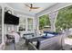 Screened-in porch area with TV and comfortable outdoor seating at 155 Preservation Circle, Pawleys Island, SC 29585