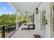 Inviting covered porch with comfortable seating and ceiling fans at 155 Preservation Circle, Pawleys Island, SC 29585
