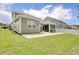 Expansive backyard showcasing a concrete patio, screened porch, and lush green lawn at 160 Juniata Loop, Little River, SC 29566