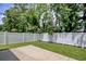 A peaceful backyard featuring a well-manicured lawn and pristine white privacy fence at 160 Juniata Loop, Little River, SC 29566