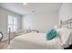 Bright bedroom features a queen bed with decorative pillows and natural light streaming through the window at 160 Juniata Loop, Little River, SC 29566