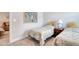 Inviting bedroom showcasing twin beds with floral quilts and a glimpse into a cozy living area at 160 Juniata Loop, Little River, SC 29566