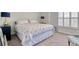 Well-lit bedroom featuring a queen bed with blue accents, complemented by modern bedside lamps at 160 Juniata Loop, Little River, SC 29566