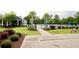 Attractive community pool area with shade umbrellas, lush landscaping, and inviting walkways at 160 Juniata Loop, Little River, SC 29566