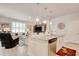 Open kitchen view into living area with stainless steel appliances and island seating at 160 Juniata Loop, Little River, SC 29566