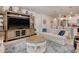 Bright living room featuring a large TV, display shelves, and comfortable seating, open to the kitchen at 160 Juniata Loop, Little River, SC 29566