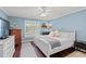 Comfortable bedroom with wood floors, a white bed frame, plantation shutters and updated ceiling fan at 1725 26Th Ave N, North Myrtle Beach, SC 29582