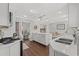 Stylish kitchen with white cabinets, stainless steel appliances, and center island open to the living area at 1725 26Th Ave N, North Myrtle Beach, SC 29582