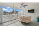 A screened-in porch with a blue ceiling fan is the perfect spot to unwind and take in the surrounding views at 1725 26Th Ave N, North Myrtle Beach, SC 29582
