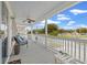 Relaxing covered porch with comfortable seating, ceiling fan, and scenic neighborhood views at 1725 26Th Ave N, North Myrtle Beach, SC 29582