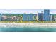 Stunning aerial view of the coastline with luxury hotels along a sandy beach, offering a vibrant coastal lifestyle at 2000 N Ocean Blvd. # 1209, Myrtle Beach, SC 29577