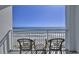 Balcony with chairs providing amazing ocean views of the white sand beach and blue water at 2000 N Ocean Blvd. # 1209, Myrtle Beach, SC 29577