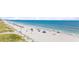 Picturesque beach view with people enjoying the sun, showcasing a lively coastal community and serene ocean at 2000 N Ocean Blvd. # 1209, Myrtle Beach, SC 29577