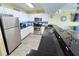 Bright kitchen boasts granite countertops, stainless steel appliances, and a breakfast bar for casual dining at 2007 S Ocean Blvd. # 604, Myrtle Beach, SC 29577