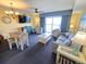 Inviting living room with a coastal design, comfortable seating, a flat-screen TV, and a balcony overlooking the ocean at 2007 S Ocean Blvd. # 604, Myrtle Beach, SC 29577